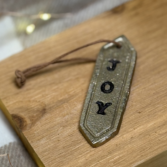 Stamped Joy Metal Ornament. Gold.